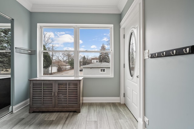 interior space featuring crown molding, wood finished floors, and baseboards