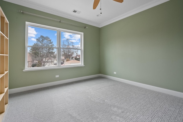 empty room with a ceiling fan, visible vents, baseboards, crown molding, and carpet flooring