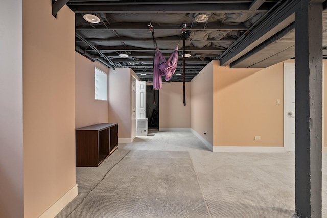 basement featuring baseboards and carpet floors