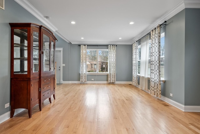 interior space featuring visible vents, baseboards, light wood-type flooring, ornamental molding, and recessed lighting