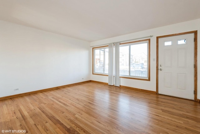 foyer featuring baseboards and light wood-style floors