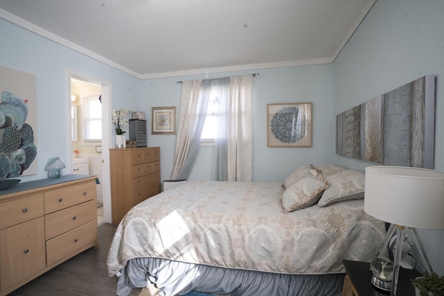 bedroom with ensuite bathroom, crown molding, and wood finished floors