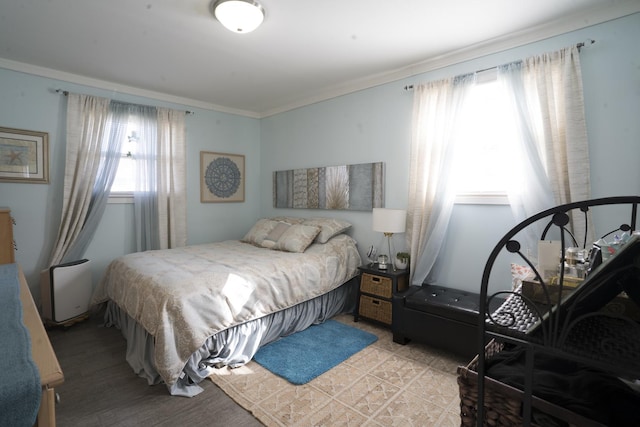 bedroom featuring multiple windows and crown molding