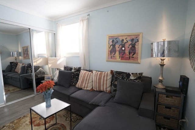 living area with wood finished floors and ornamental molding