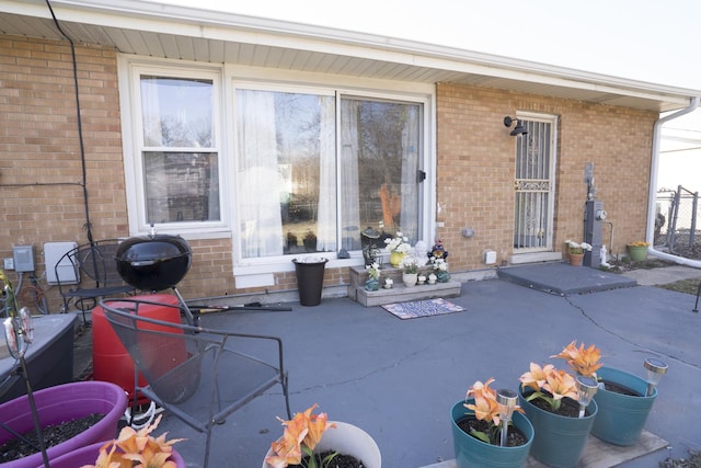 exterior space with a patio area and brick siding