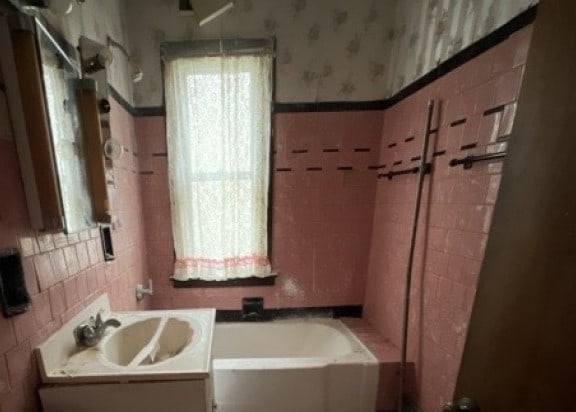 bathroom featuring a tub and vanity