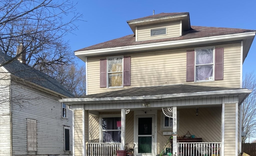 rear view of house featuring a porch