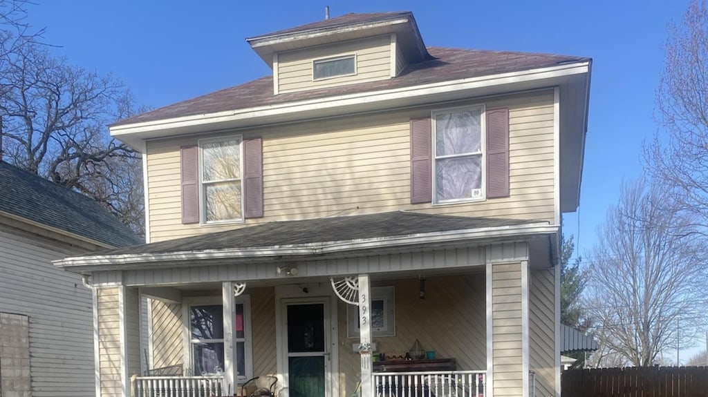 american foursquare style home with a porch