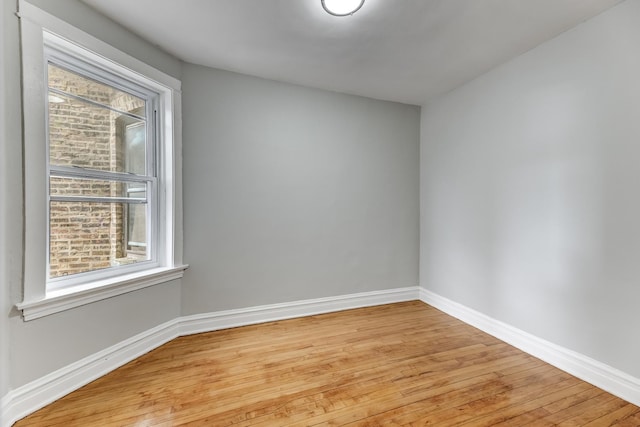 empty room with light wood-style floors and baseboards