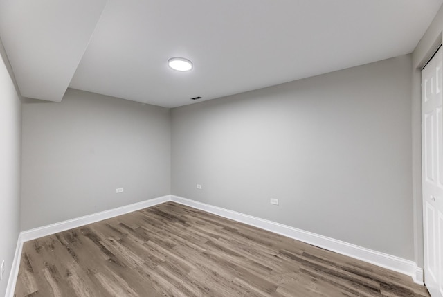 unfurnished bedroom with visible vents, baseboards, and wood finished floors