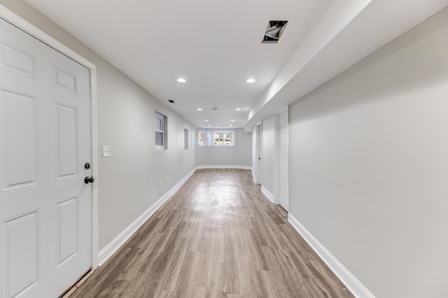 hallway with light wood-style flooring, recessed lighting, and baseboards