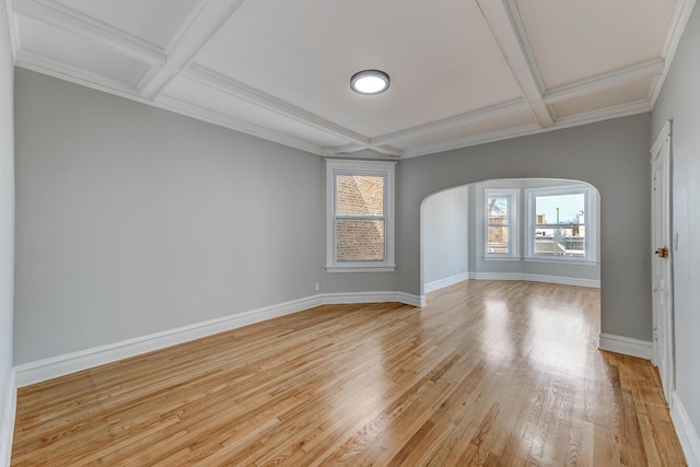 unfurnished room featuring baseboards, coffered ceiling, arched walkways, light wood-style floors, and beamed ceiling