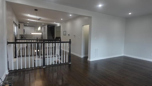 unfurnished room featuring visible vents, recessed lighting, baseboards, and dark wood-style flooring