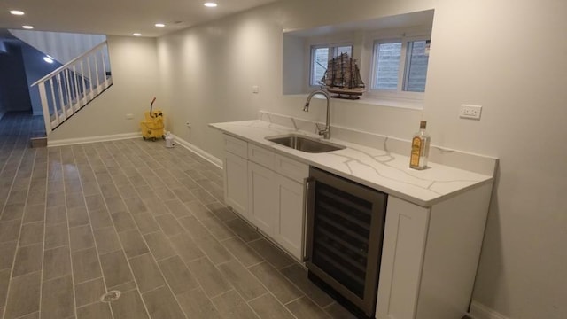 bar featuring a sink, dark wood finished floors, recessed lighting, wine cooler, and stairs