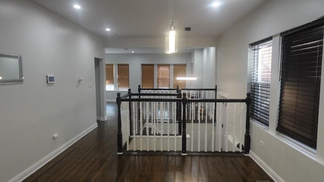 hall featuring wood finished floors, recessed lighting, an upstairs landing, and baseboards