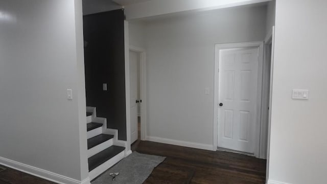 interior space with baseboards and wood finished floors