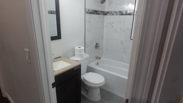 bathroom featuring tile patterned floors, toilet, vanity, and shower / tub combination