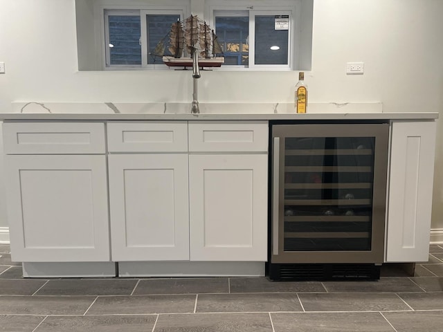 bar featuring bar area, beverage cooler, and wood finish floors