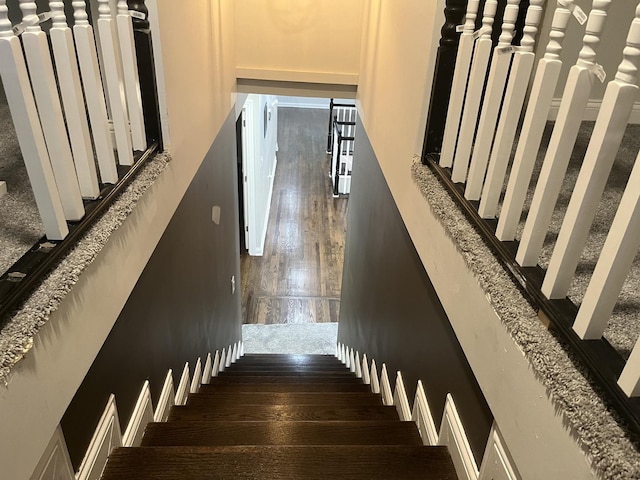 stairs featuring wood finished floors