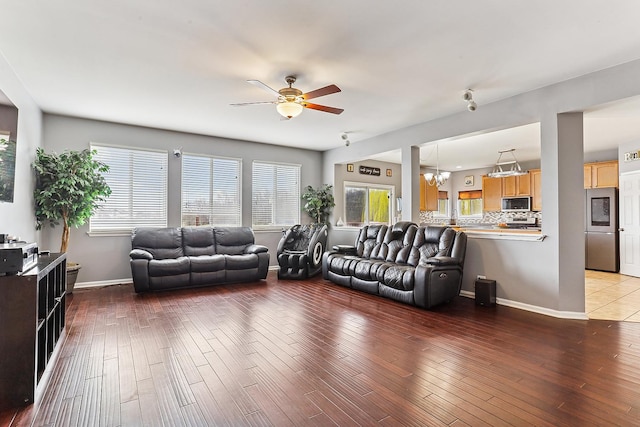 330 Alexis St, Plano, IL 60545 - living area with ceiling fan with notable chandelier, baseboards, and wood finished floors