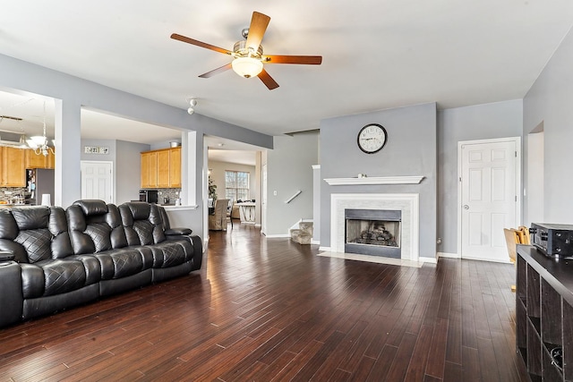 330 Alexis St, Plano, IL 60545 - living area featuring a fireplace with flush hearth, dark wood-style floors, baseboards, and ceiling fan