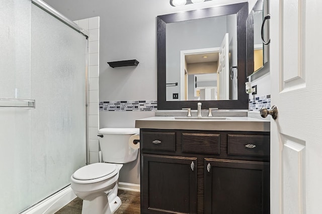 330 Alexis St, Plano, IL 60545 - full bathroom with vanity, a baseboard heating unit, toilet, a shower stall, and wood finished floors