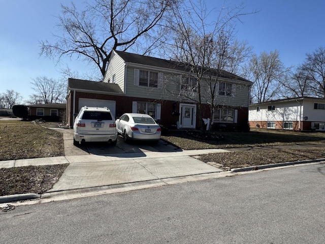 colonial home with concrete driveway and an attached garage