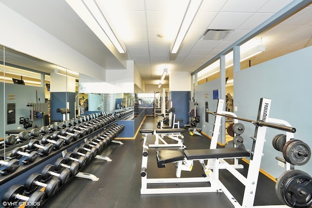 exercise room with visible vents and a paneled ceiling