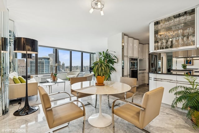 dining area with a city view and marble finish floor