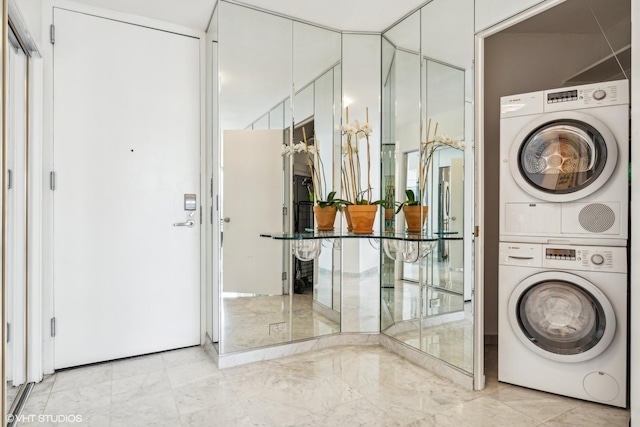 laundry room with stacked washer / drying machine and laundry area