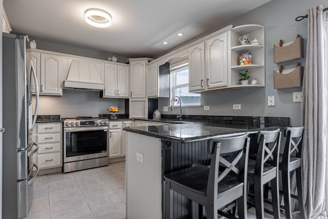 kitchen featuring a breakfast bar area, custom range hood, light tile patterned floors, a peninsula, and appliances with stainless steel finishes