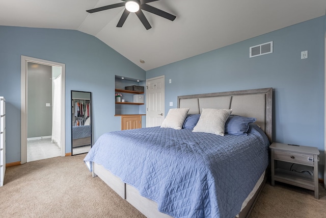 bedroom featuring visible vents, baseboards, ceiling fan, carpet floors, and vaulted ceiling