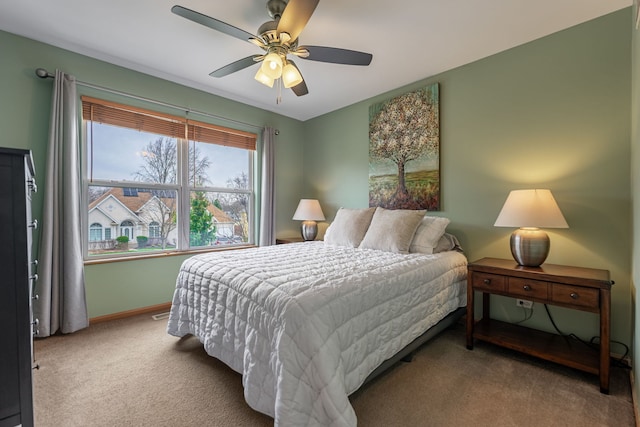 carpeted bedroom with baseboards and ceiling fan
