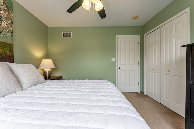bedroom with a closet, carpet floors, and a ceiling fan