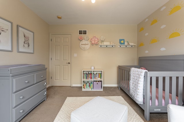 bedroom featuring visible vents, a crib, baseboards, wallpapered walls, and carpet floors