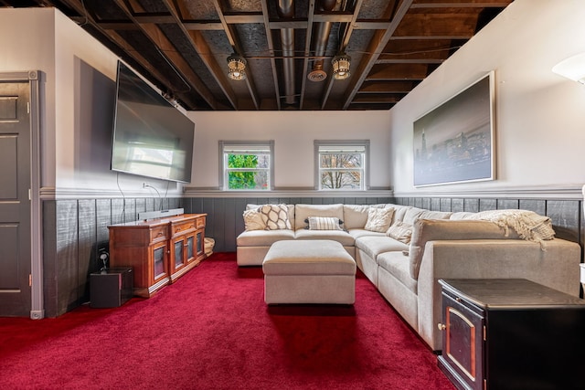 carpeted living area featuring a wainscoted wall and beamed ceiling