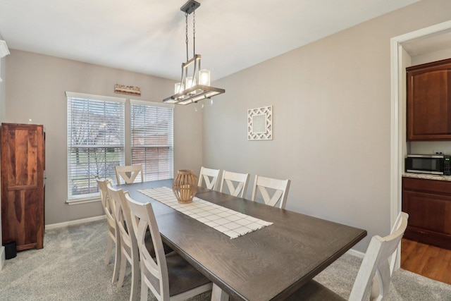 2734 Carrington Dr, West Dundee, IL 60118 - dining space with baseboards, a chandelier, and light colored carpet