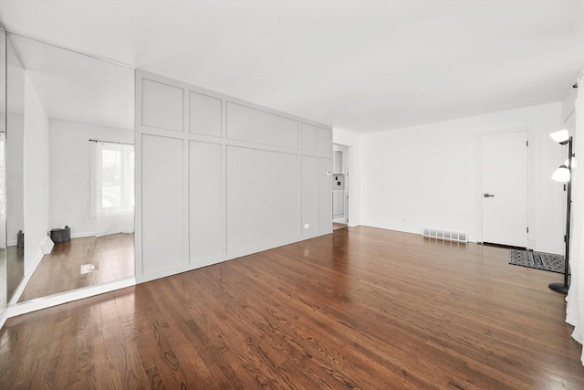 interior space with visible vents and dark wood-type flooring