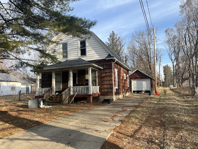 809 W Columbia St, Danville, IL 61832 - view of front of house with a porch, aphalt driveway, an outdoor structure, a garage, and a shingled roof