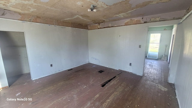 809 W Columbia St, Danville, IL 61832 - spare room with wooden walls and hardwood / wood-style floors