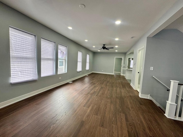 unfurnished living room with recessed lighting, baseboards, dark wood-type flooring, and ceiling fan