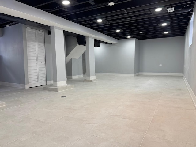 finished basement featuring recessed lighting and baseboards