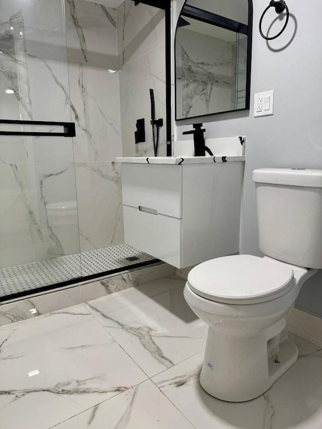 bathroom featuring a marble finish shower, toilet, marble finish floor, and vanity