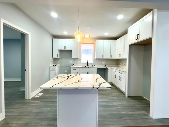 kitchen featuring white cabinetry, recessed lighting, dark wood-style flooring, and a kitchen island