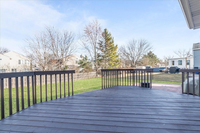 wooden terrace featuring a fenced backyard, a residential view, and a yard