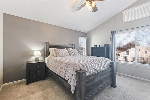 bedroom with lofted ceiling, baseboards, and light carpet