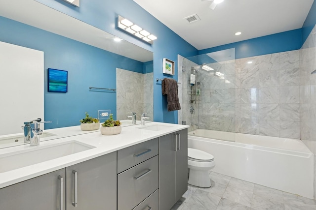 full bath with toilet, visible vents, marble finish floor, and a sink