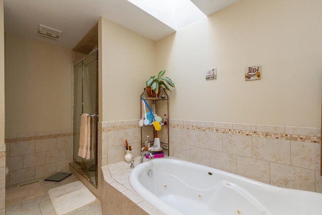 full bath featuring tile patterned floors, visible vents, a tub with jets, and a shower stall