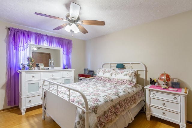 bedroom featuring a ceiling fan and light wood finished floors