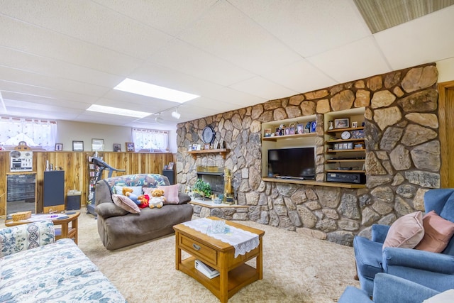 carpeted living room with wainscoting and a fireplace